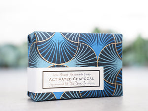 Large 6oz bar of activated charcoal soap wrapped in beautiful art deco blue and black gold flocked paper handmade with peppermint and tea tree essential oils.
